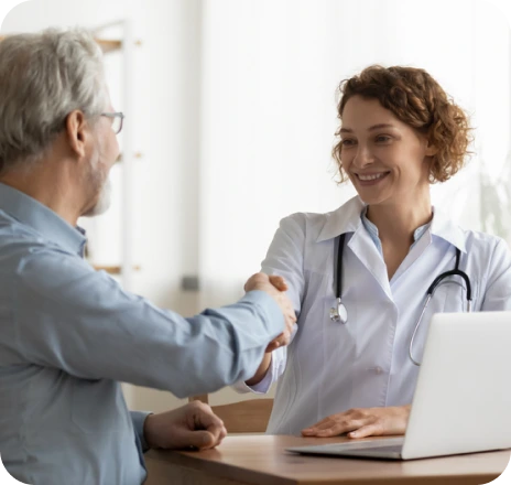 doctor shaking hands with an elderly patient